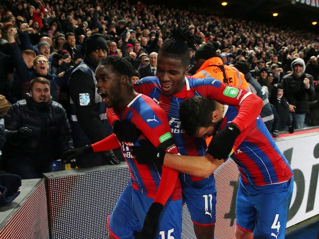 Crystal Palace's Jeffrey Schlupp celebrates scoring their first goal with Wilfried Zaha and Luka Milivojevic on December 3, 2019
