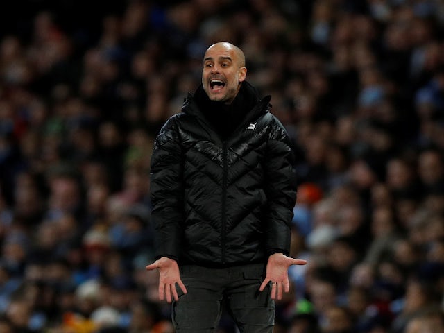 Pep Guardiola watches on during the Premier League game between Manchester City and Manchester United on December 7, 2019