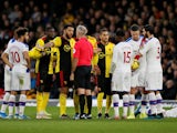 Referee Martin Atkinson speaks with Watford's Troy Deeney as Crystal Palace's Luka Milivojevic reacts after sustaining an injury on December 7, 2019