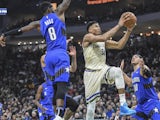 Milwaukee Bucks forward Giannis Antetokounmpo (34) takes a shot between Orlando Magic guard Terrence Ross (8) and forward Aaron Gordon (00) in the second quarter at Fiserv Forum on December 10, 2019