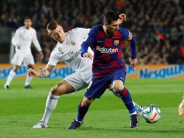 Barcelona's Lionel Messi in action with Real Madrid's Toni Kroos in La Liga at Camp Nou on December 18, 2019