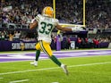 Green Bay Packers running back Aaron Jones (33) carries the ball for a touchdown during the third quarter against the Minnesota Vikings at U.S. Bank Stadium on December 24, 2019