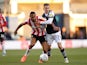 Brentford's Ethan Pinnock in action with Millwall's Jed Wallace on December 29, 2019