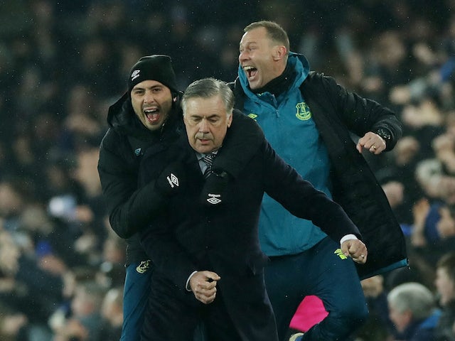 Everton manager Carlo Ancelotti celebrates their first goal scorted by Everton's Dominic Calvert-Lewin with coach Duncan Ferguson and assistant manager Davide Ancelotti on December 26, 2019