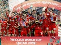 Liverpool's Jordan Henderson lifts the trophy as they celebrate after winning the Club World Cup on December 21, 2019
