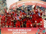 Liverpool's Jordan Henderson lifts the trophy as they celebrate after winning the Club World Cup on December 21, 2019
