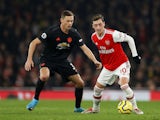 Arsenal's Mesut Ozil in action with Manchester United's Nemanja Matic in the Premier League on January 1, 2020