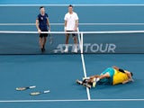 Australia's Alex de Minaur and Nick Kyrgios celebrate winning their Quarter Final doubles match against Britain's Jamie Murray and Joe Salisbury as they look on dejected on January 9, 2020