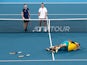 Australia's Alex de Minaur and Nick Kyrgios celebrate winning their Quarter Final doubles match against Britain's Jamie Murray and Joe Salisbury as they look on dejected on January 9, 2020
