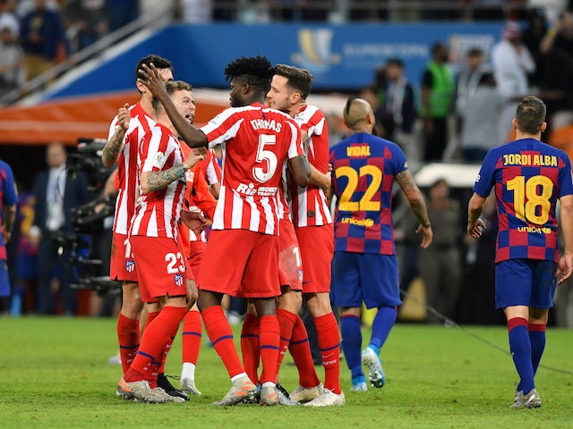 Atletico Madrid's Kieran Trippier celebrates with Thomas Partey and teammates after the match on January 9, 2020