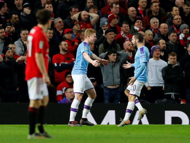 Kevin De Bruyne celebrates Andreas Pereira's own goal with Bernardo Silva during the EFL Cup game between Manchester United and Manchester City on January 7, 2020