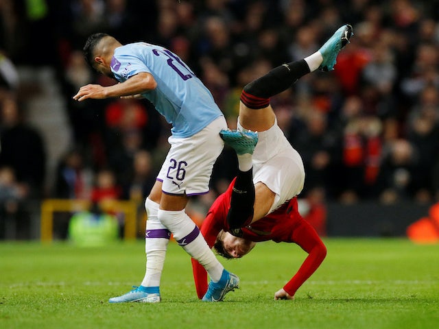 Riyad Mahrez in action with Brandon Williams during the EFL Cup game between Manchester United and Manchester City on January 7, 2020