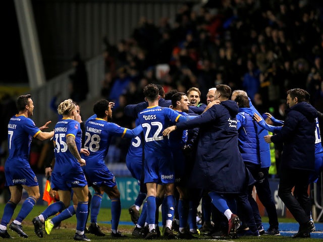 Shrewsbury Town's Aaron Pierre celebrates scoring their first goal with teammates and Shrewsbury Town manager Sam Ricketts on January 14, 2020