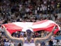 Denmark's Caroline Wozniacki holds the flag of Denmark as she heads into retirement after losing the match against Tunisia's Ons Jabeur on January 24, 2020.