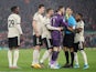 Manchester United's David de Gea is held back by Luke Shaw as he remonstrates with referee Craig Pawson, who is held by Fred on January 19, 2020