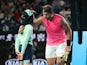 Spain's Rafael Nadal passes the ball girl his head band after winning the match against Argentina's Federico Delbonis on January 23, 2020
