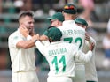 South Africa's Dane Paterson celebrates with teammates after taking the wicket of England's Joe Denly on January 24, 2020