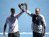 Rajeev Ram of the U.S. and Britain's Joe Salisbury celebrate with the trophy after winning the final against Australia's Max Purcell and Luke Saville on February 2, 2020