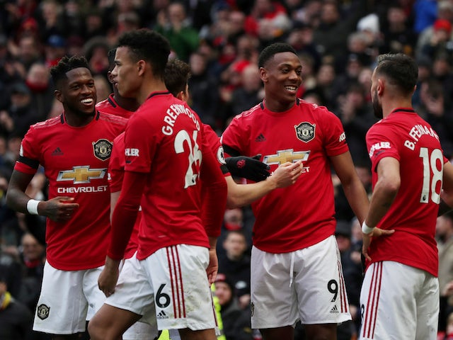 Manchester United's Anthony Martial celebrates scoring their second goal with Bruno Fernandes and teammates on February 23, 2020