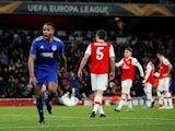 Olympiacos' Youssef El-Arabi celebrates scoring their second goal as Arsenal players look dejected on February 27, 2020