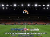 The teams line up before the match in an empty stadium after fans were not allowed in over coronavirus fears at San Siro on February 27, 2020