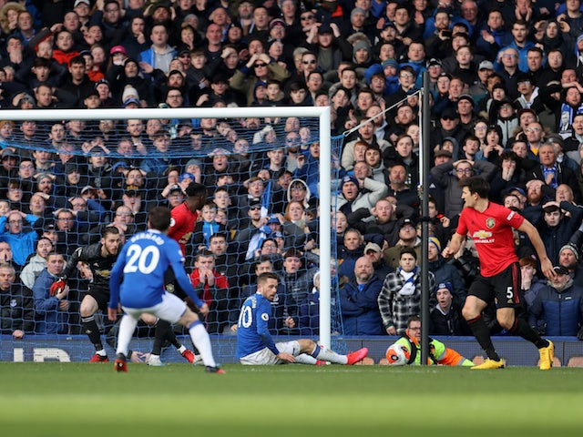 A shot from Everton's Dominic Calvert-Lewin deflects off Manchester United's Harry Maguire into the net before the goal is disallowed for offside against Everton's Gylfi Sigurdsson on March 1, 2020