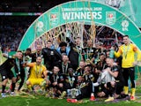 Manchester City players pose with the trophy as they celebrate winning the EFL Cup on March 1, 2020