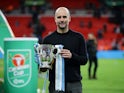 Manchester City manager Pep Guardiola celebrates winning the EFL Cup with the trophy on March 1, 2020