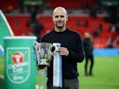 Manchester City manager Pep Guardiola celebrates winning the EFL Cup with the trophy on March 1, 2020