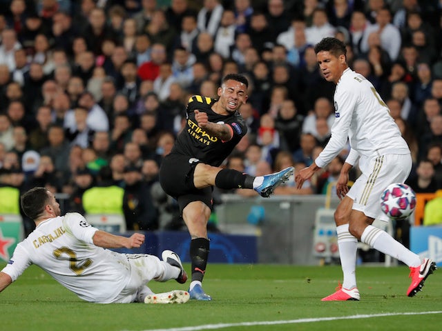 Manchester City's Gabriel Jesus shoots at goal as Real Madrid's Dani Carvajal and Raphael Varane attempt to block on February 26, 2020