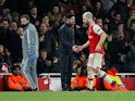 Arsenal's Shkodran Mustafi shakes hands with manager Mikel Arteta as he is substituted off on February 27, 2020