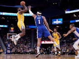 Golden State Warriors forward Eric Paschall (7) shoots the ball over Philadelphia 76ers forward Mike Scott (1) in the fourth quarter at the Chase Center on March 8, 2020