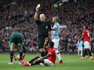 Manchester United's Fred is shown a yellow card by referee Mike Dean on March 8, 2020