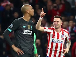 Atletico Madrid's Saul Niguez celebrates scoring their first goal as Liverpool's Fabinho looks dejected on February 18, 2020