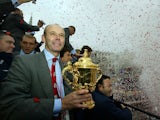 England coach Clive Woodward, holding the William Webb Ellis trophy, accompanies the 2003 Rugby World Cup squad as they arrive in Trafalgar Square at the end of their parade through the capital to mark the team's victory, in London, Britain, December 8, 2