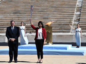 Greece hands Olympic flame over to hosts Japan despite coronavirus concerns