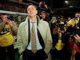 Barcelona coach Johan Cruyff looks on as he is surrounded by photographers after his team defeated Dutch PSV Eindhoven in the second leg of the UEFA Cup quarter final match in Eindhoven, March 19 1996