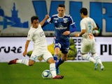 Marseille's Maxime Lopez in action with Strasbourg's Anthony Caci in October 2019