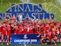 Saracens players celebrate winning the final with the trophy after the match in May 2019
