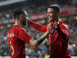 Portugal's Bruno Fernandes celebrates with Cristiano Ronaldo after scoring their second goal in June 2018