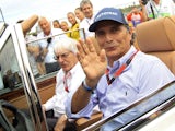 Former Formula One driver Nelson Piquet of Brazil (R) and Formula One supremo Bernie Ecclestone arrive at the drivers parade before the Hungarian F1 Grand Prix at the Hungaroring circuit, near Budapest, Hungary July 26, 2015