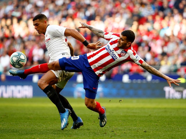 Atletico Madrid's Angel Correa in action with Sevilla's Diego Carlos in La Liga on March 7, 2020