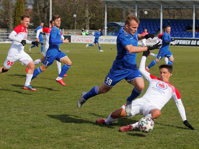 Belarusian football sees Slutsk's Roman Krivulkin in action with Slavia-Mozyr's Igor Costrov in March 2020