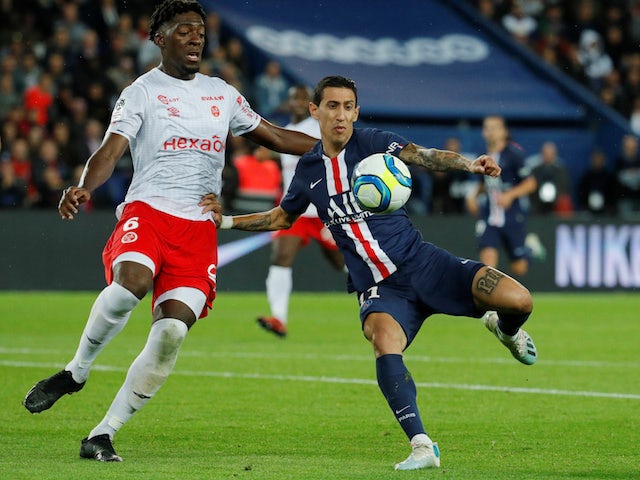 Paris Saint-Germain's Angel Di Maria in action with Reims defender Axel Disasi in September 2019