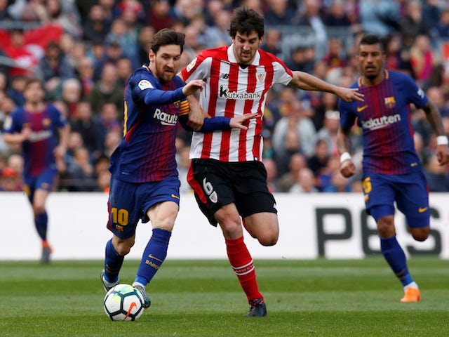 Athletic Bilbao's Mikel San Jose battles Lionel Messi for possession in 2018