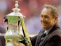 Former Liverpool boss Gerard Houllier celebrates with the FA Cup trophy in 2001