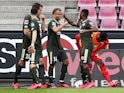 Mainz players celebrate equalising against Koln on May 17, 2020