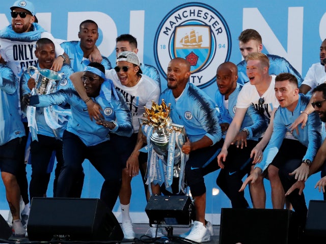Manchester City's player celebrate with the Premier League trophy in May 2018