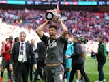 Alex Revell celebrates with the playoff trophy for Rotherham in 2014