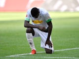 Borussia Monchengladbach's Marcus Thuram takes a knee after scoring on May 31, 2020